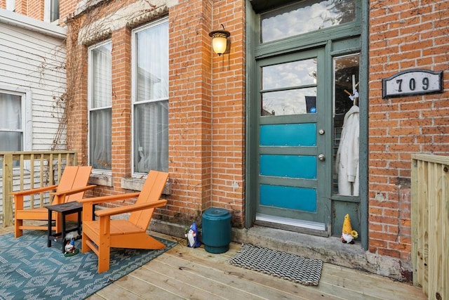 entrance to property featuring a wooden deck