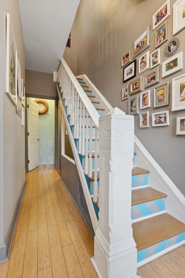 stairs featuring wood-type flooring