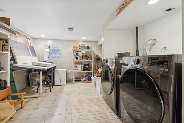 washroom with washing machine and dryer and light tile patterned floors