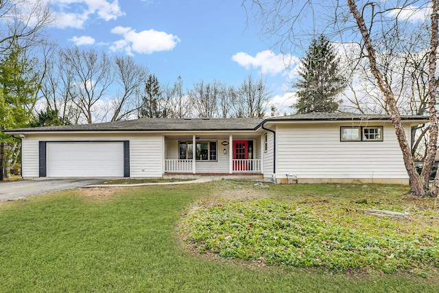 single story home with covered porch, a front yard, and a garage