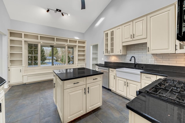 kitchen with tasteful backsplash, sink, cream cabinets, high vaulted ceiling, and dishwasher