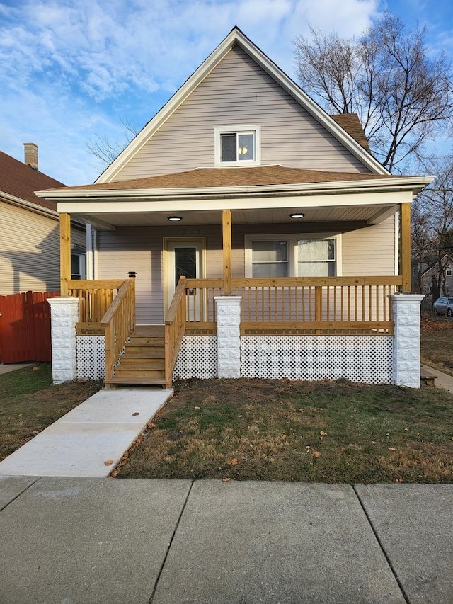 bungalow with a porch and a front yard