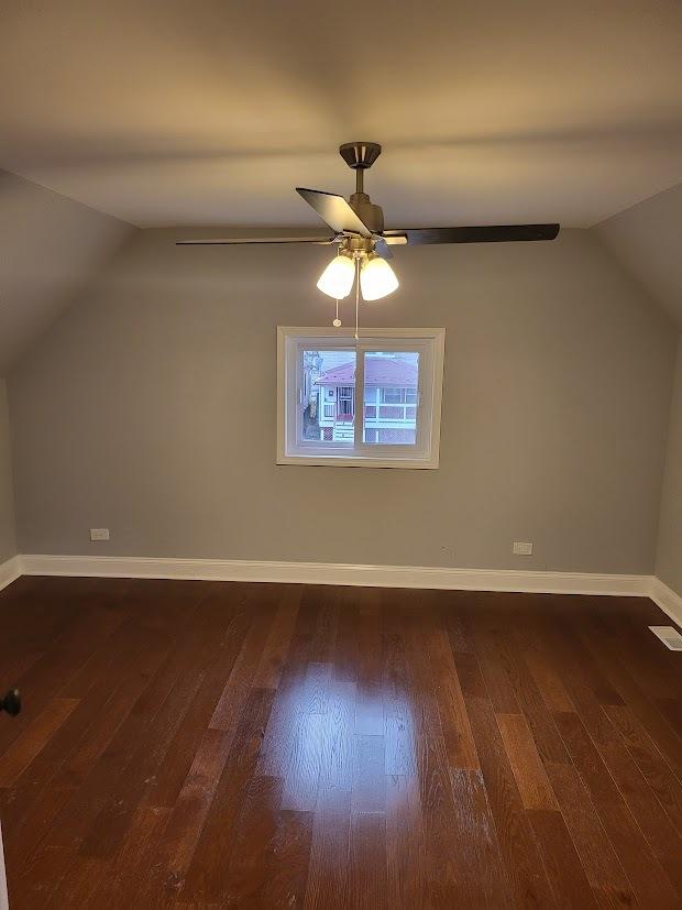 bonus room featuring ceiling fan, dark hardwood / wood-style floors, and vaulted ceiling