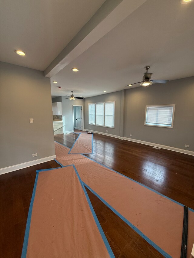 empty room with dark wood-style floors and baseboards