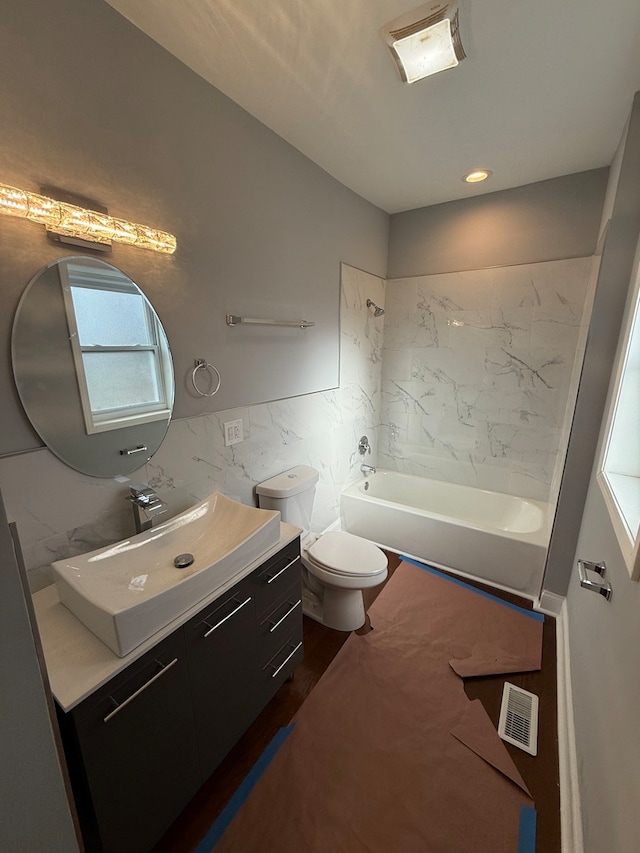 full bathroom featuring visible vents, toilet, tile walls, and vanity