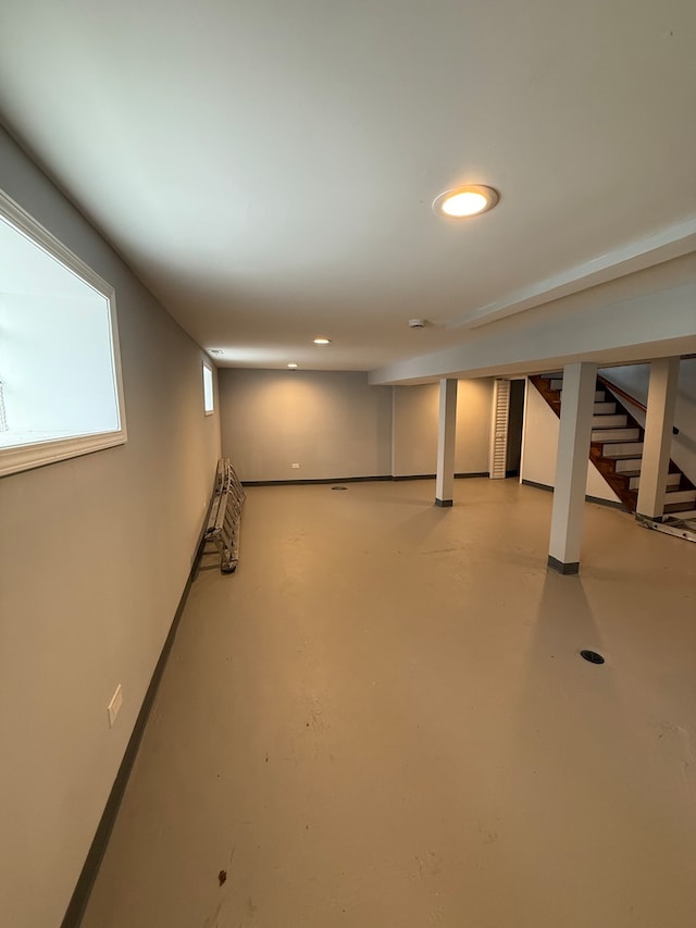 basement with baseboards and recessed lighting