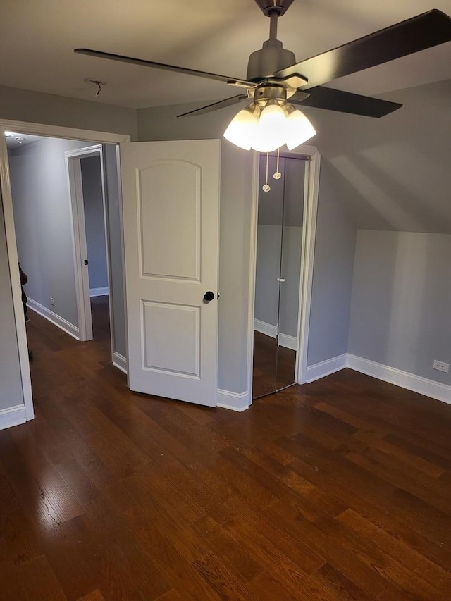 bonus room featuring dark wood-style floors, baseboards, vaulted ceiling, and a ceiling fan