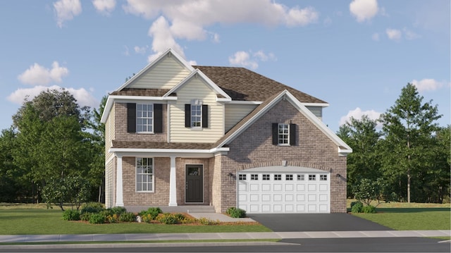 view of front of property with a front yard and a garage