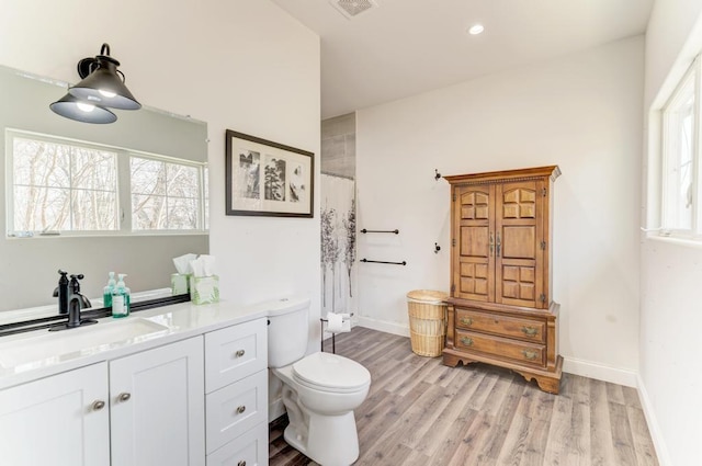 bathroom featuring hardwood / wood-style flooring, vanity, and toilet