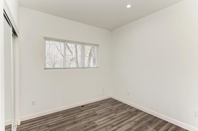 empty room with dark hardwood / wood-style floors