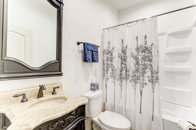 full bathroom with shower / bath combo, vanity, and toilet