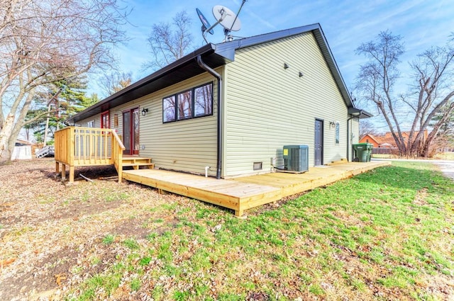 rear view of property with central AC, a wooden deck, and a lawn