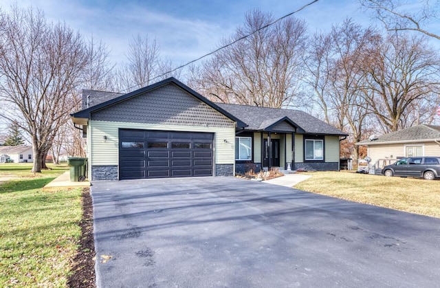 view of front of property featuring a front yard and a garage