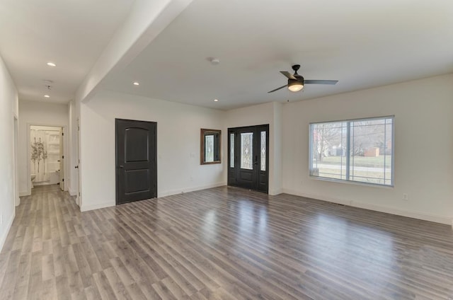 unfurnished living room with ceiling fan and light wood-type flooring