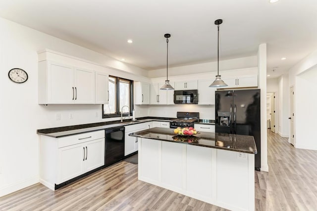 kitchen with a center island, black appliances, light hardwood / wood-style flooring, decorative light fixtures, and white cabinetry