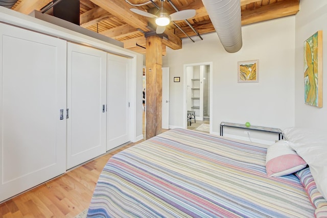 bedroom with wood ceiling, ensuite bathroom, beamed ceiling, and light wood-type flooring