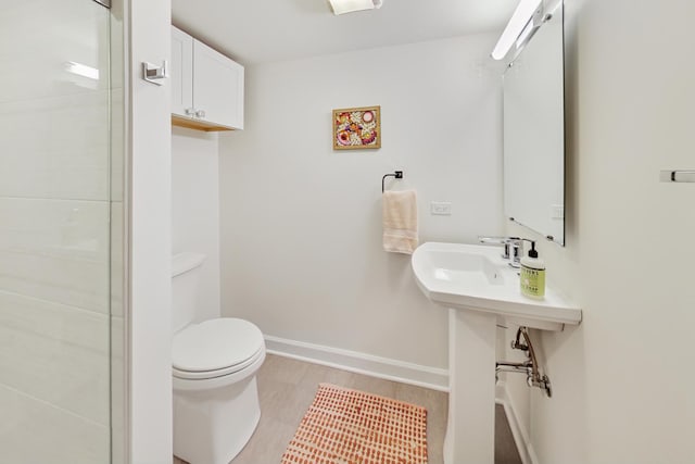 bathroom with wood-type flooring and toilet