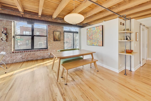 dining area with wood-type flooring, brick wall, and wooden ceiling