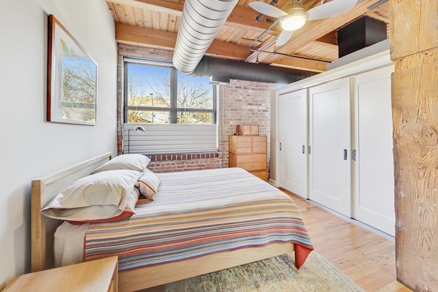 bedroom featuring wood ceiling, beam ceiling, and light hardwood / wood-style floors