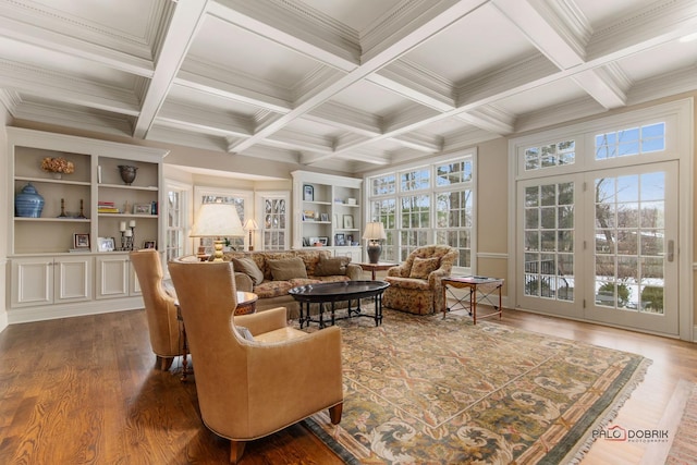 living room featuring dark hardwood / wood-style flooring, crown molding, built in features, and beamed ceiling