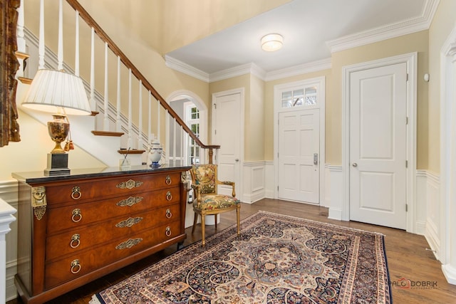 foyer featuring ornamental molding and dark hardwood / wood-style floors