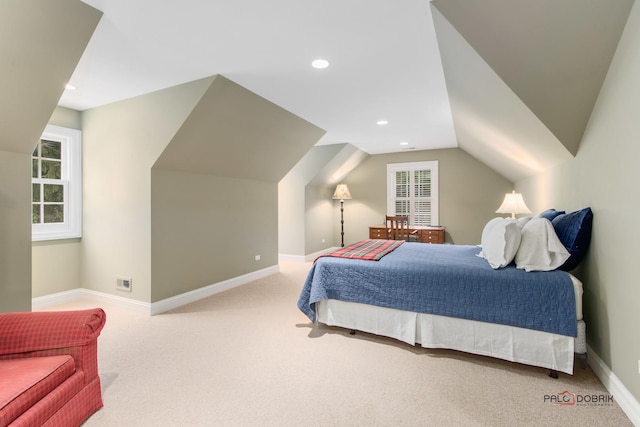 bedroom with lofted ceiling and light colored carpet