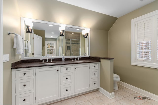 bathroom with vanity, a shower with door, tile patterned floors, and toilet