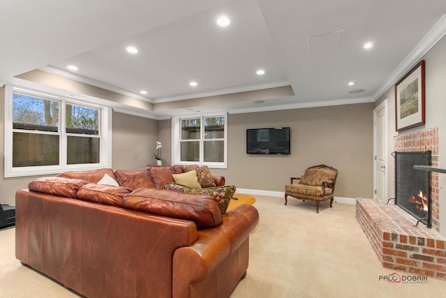 living room with a brick fireplace, crown molding, and light colored carpet