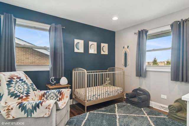 bedroom with dark hardwood / wood-style flooring