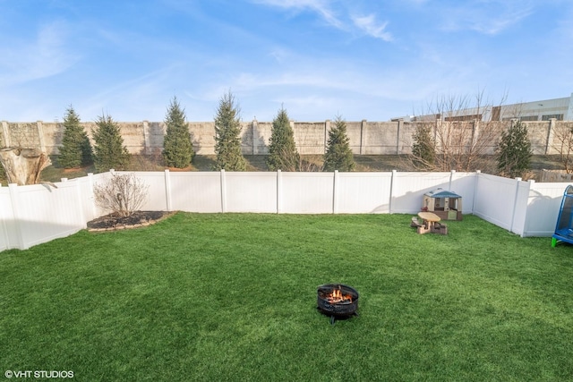 view of yard with an outdoor fire pit