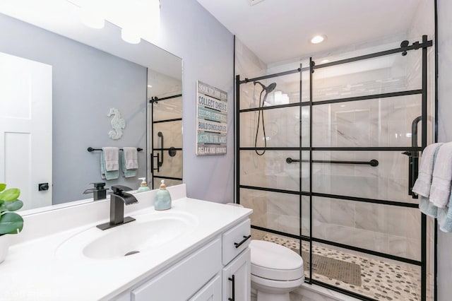 bathroom featuring vanity, toilet, and walk in shower