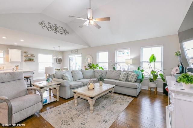 living room featuring ceiling fan, dark hardwood / wood-style flooring, and vaulted ceiling