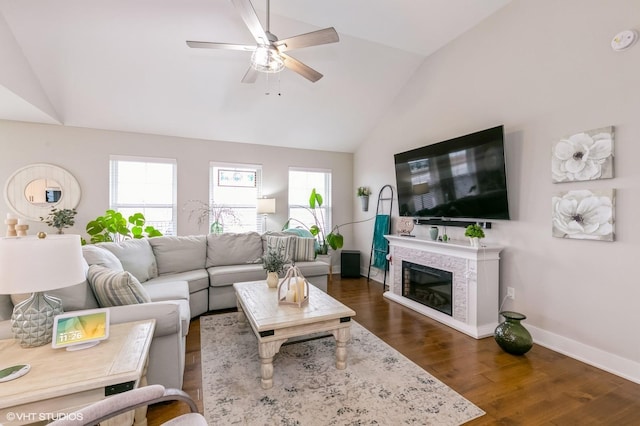 living room with dark wood-type flooring, ceiling fan, and lofted ceiling