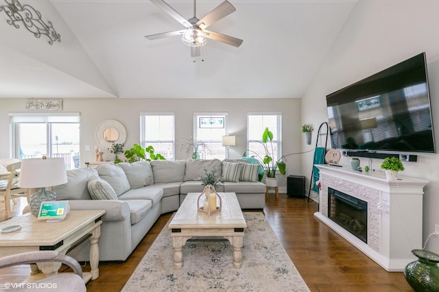 living room with ceiling fan, plenty of natural light, high vaulted ceiling, and dark hardwood / wood-style floors