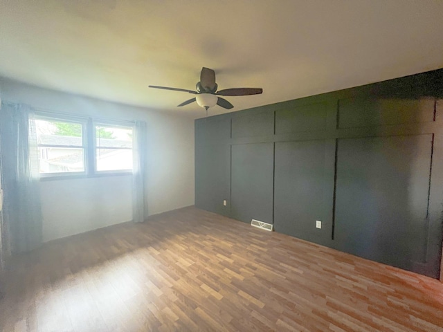 unfurnished bedroom featuring ceiling fan and hardwood / wood-style flooring