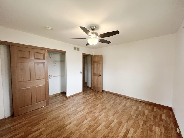 unfurnished bedroom featuring ceiling fan, a closet, and light hardwood / wood-style floors