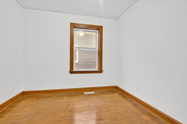 empty room with light hardwood / wood-style flooring