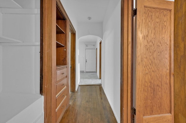 hallway with dark hardwood / wood-style flooring