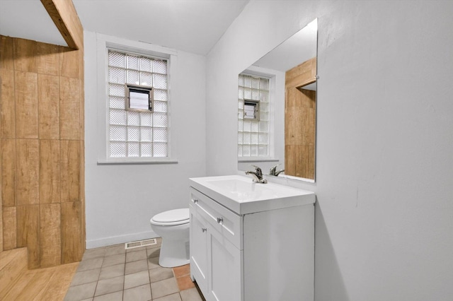 bathroom featuring tile patterned floors, vanity, and toilet