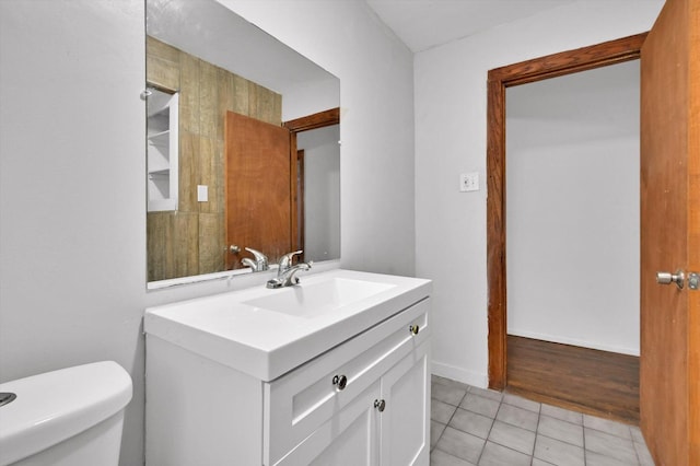 bathroom featuring toilet, vanity, and tile patterned floors