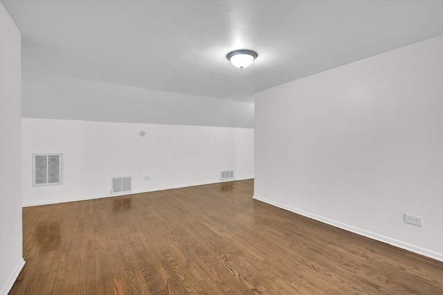 bonus room featuring wood-type flooring and vaulted ceiling