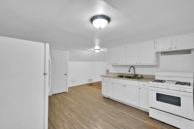 kitchen with white cabinetry, white appliances, sink, and light hardwood / wood-style flooring