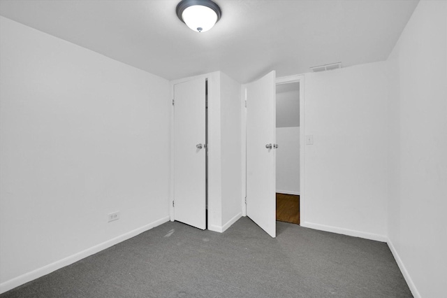 unfurnished bedroom featuring dark colored carpet