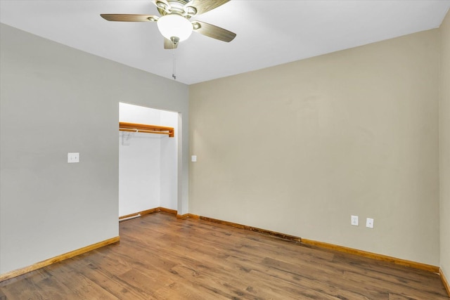 spare room featuring wood-type flooring and ceiling fan