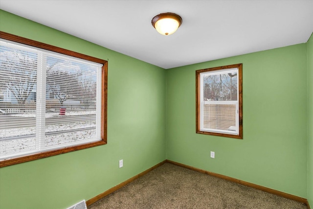 unfurnished room featuring carpet