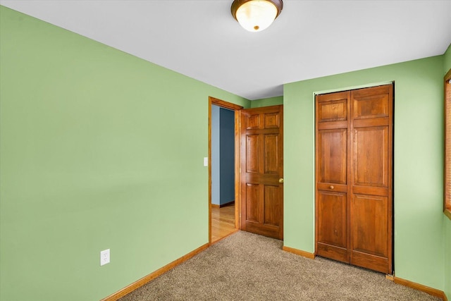 unfurnished bedroom featuring light carpet