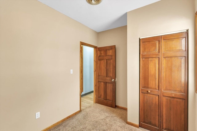 unfurnished bedroom featuring light carpet