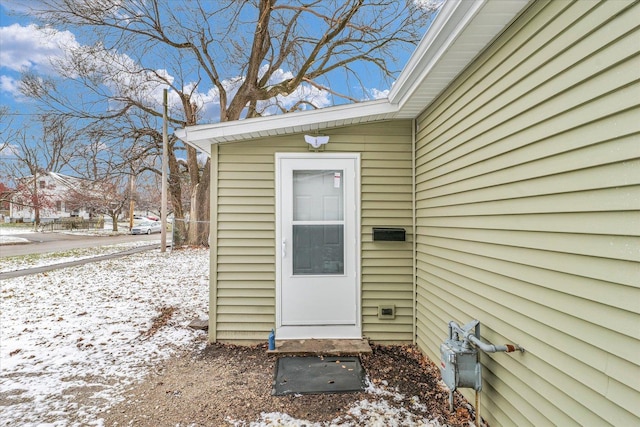 view of snow covered property entrance