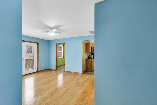 empty room featuring light hardwood / wood-style floors and ceiling fan