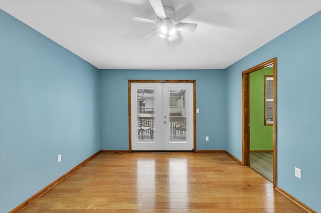 spare room featuring ceiling fan, french doors, and light wood-type flooring